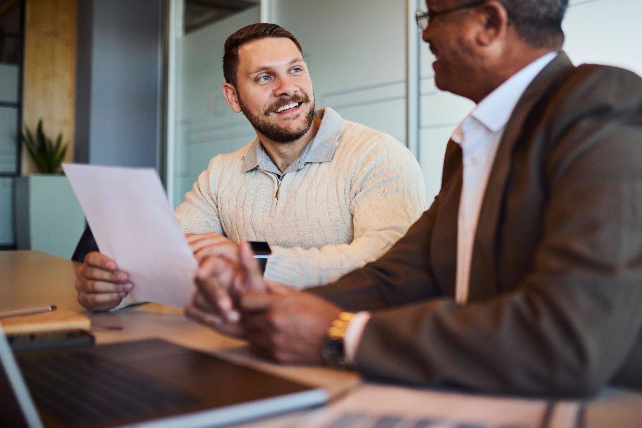 Professionals reviewing documents during a business consultation